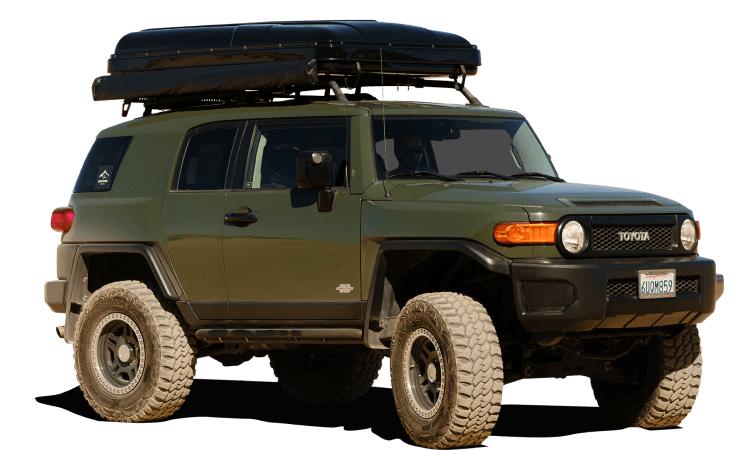 A Toyota FJ Cruiser with a Top Dog hard shell rooftop tent mounted on the roof rack