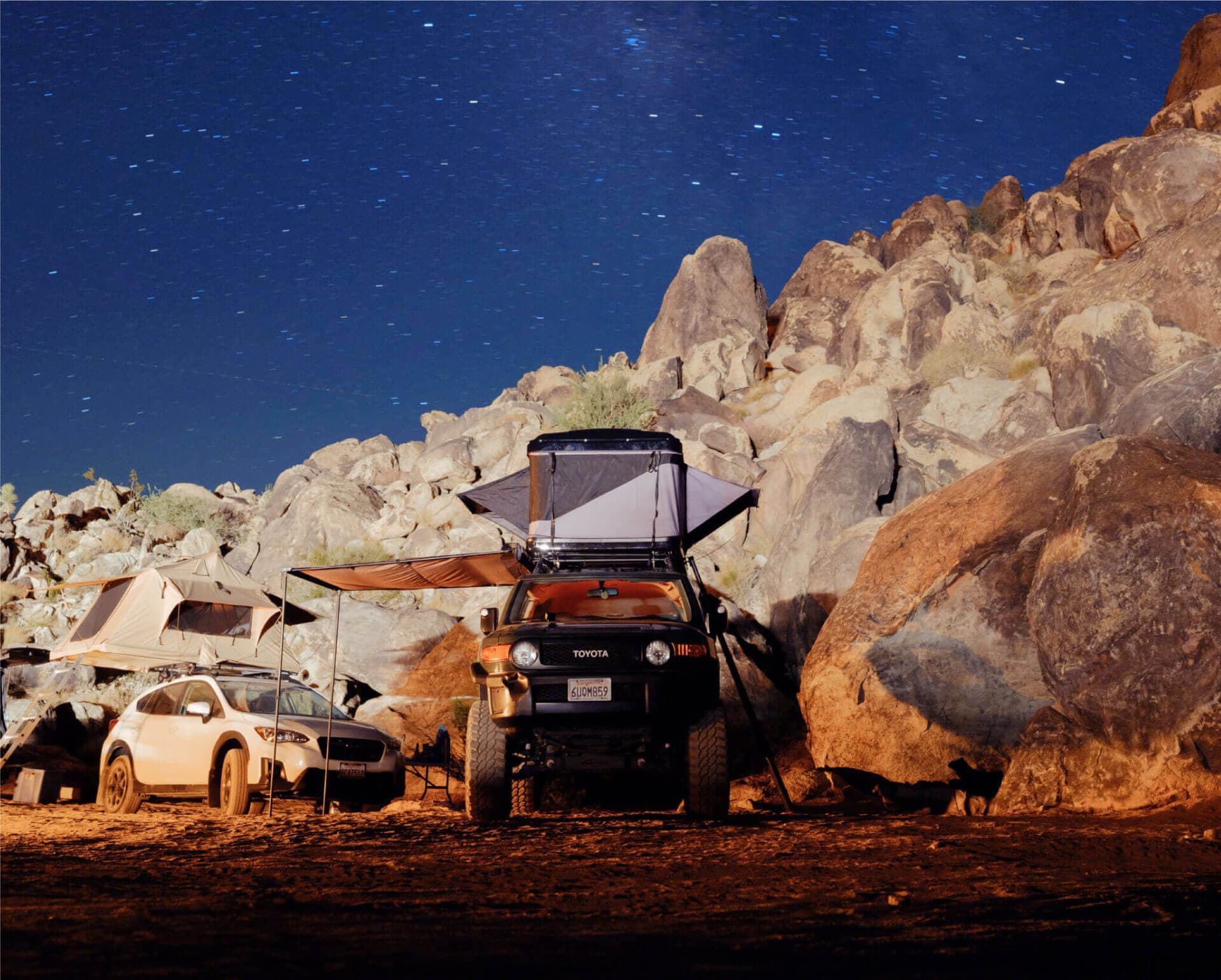 A Top Dog rooftop tent set up at a campsite
